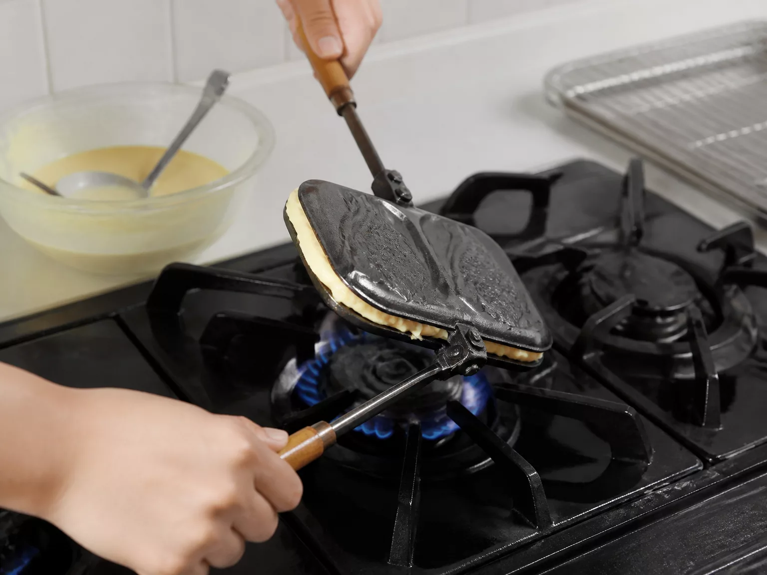 Step 5: Flip the pan immediately after closing so the batter coats both…