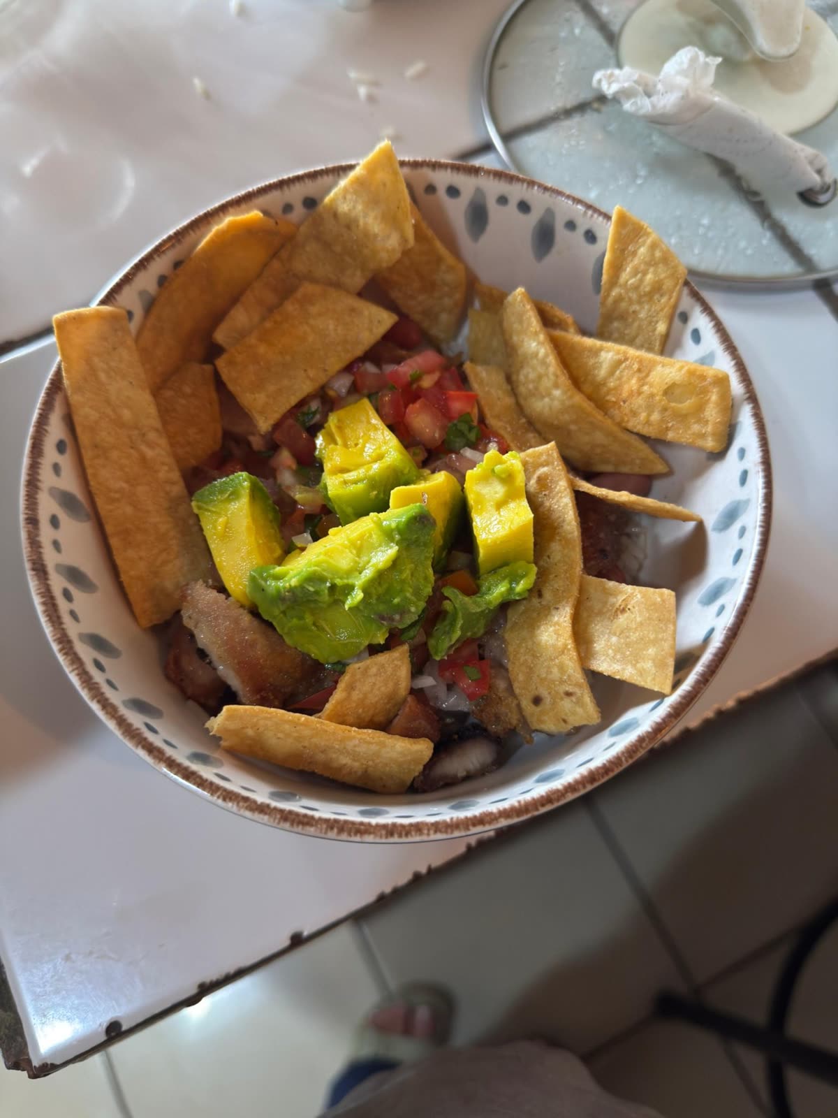 A bowl with meat, fresh salsa, avocado, and tortilla chips. — How ordering works — 54 ingredients, 6 proteins