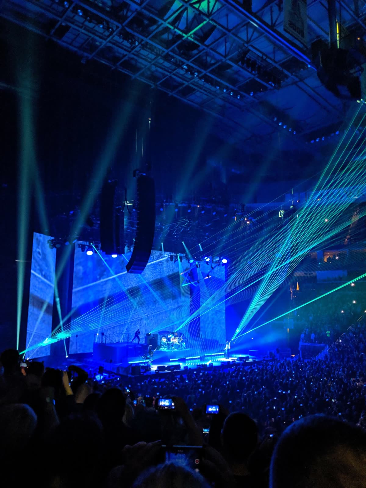 A concert stage shooting lights out into a dark arena. — BTS iHeart Radio Music Festival 2026 where to watch replay setlist: date, time, stream