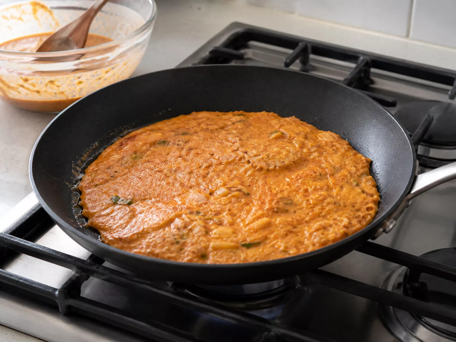Step 4: Spread the batter about 1 cm thin in the pan and leave it undisturbed…