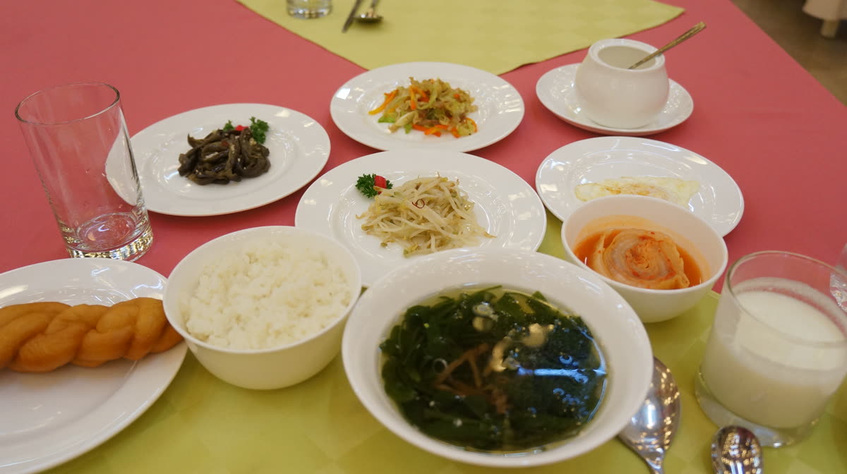 Korean breakfast at the Koryo Hotel (15957479779) — What is a typical Korean breakfast? Rice, soup and banchan on one table