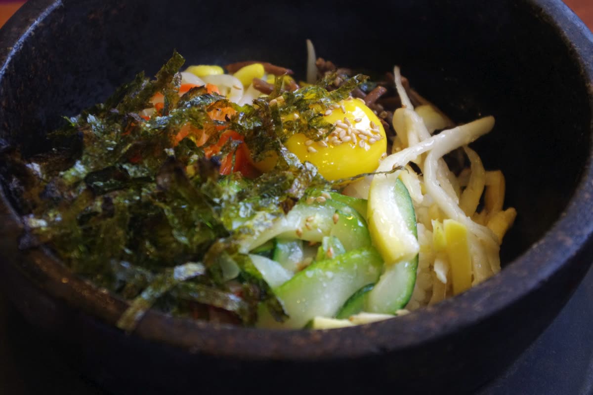 Bibimbap in stone bowl 비빔밥 (5534738694) — Convenience store bibimbap: the three flavors are Pychang radish, gondele, and Jeonju beef
