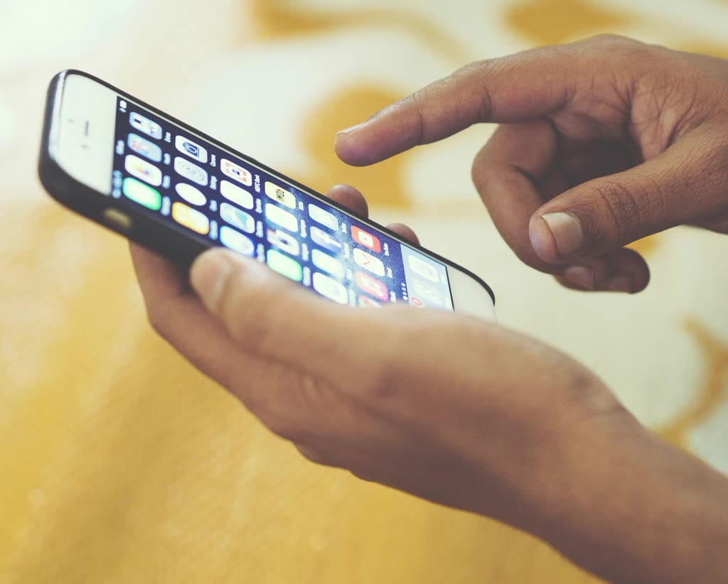 Hand swiping iPhone screen, location — How to Apply: Fanclub Lottery and What to Verify