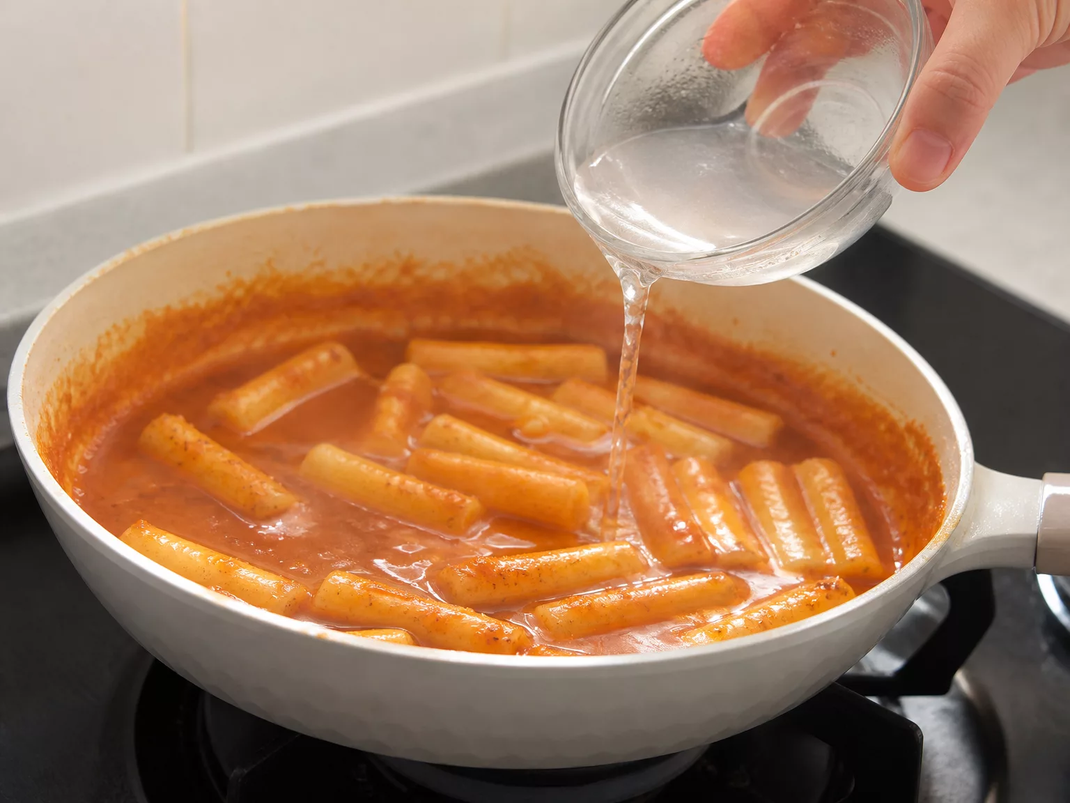 Step 7: If the sauce thickens before the tteok are tender, loosen it with…